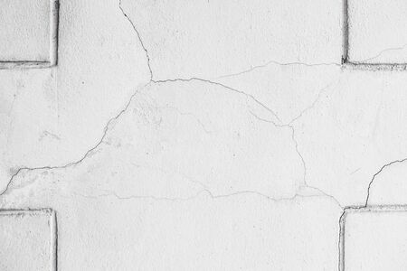 Close-up of White cement wall peeled paint caused by water and sunlight. Peel wall with line Line at the corner of White house paint with black stain. Black and White of Texture background.の写真素材