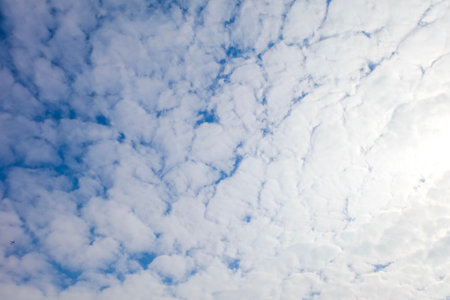 Beautiful fluffy white clouds or Altocumulus with blue sky and Sunlight, Nature background.
