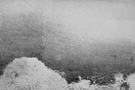 Close-up of White cement crack wall and peeled paint caused by water and sunlight. Peel wall of White house paint with black stain. Black and White of Texture background.の写真素材