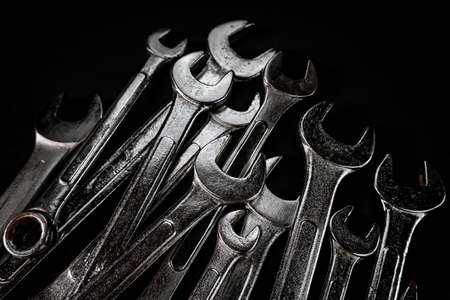 Many wrench metal with black background. Maintenance equipment and repair. Old hand tools.の写真素材