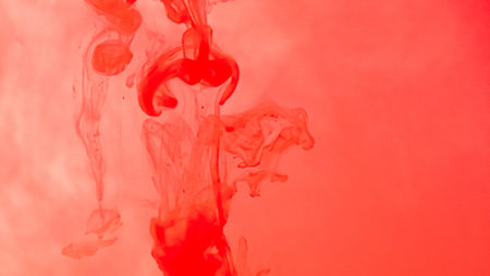 Red ink drop in water on white background. Watercolor paint splash abstract.