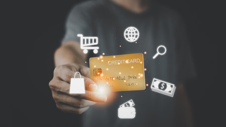 Businessman hand hold gold credit card and hologram with online shopping. Futuristic e-commerce online shopping concept.の写真素材