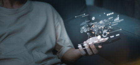 AI (Artificial intelligence) concept. Businessman hand touch hologram technology with tablet. Computer big data and information in business.の写真素材