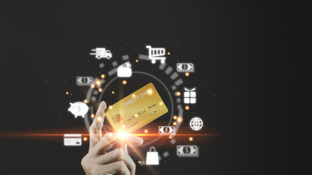 Businessman hand hold gold credit card and hologram with online shopping. Futuristic e-commerce online shopping concept.の写真素材