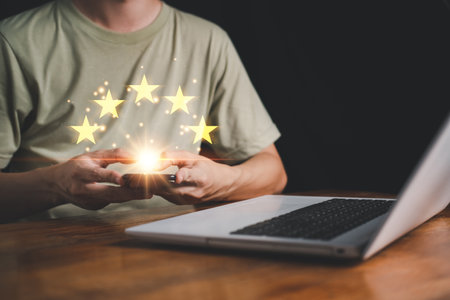 5 Star rating on hand man with smartphone. Customer evaluation feedback. Customer service evaluation and satisfaction and feedback survey concept for best excellent business rating experience.の写真素材