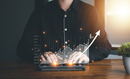 Success business concept. Buy and Sell of Stock chart or Cryptocurrency. Businessman hand touch hologram of chart with notebook (Laptop) and smartphone. Statistics graph and char growing graph.の写真素材