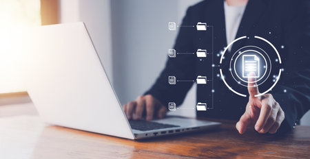 Document Management System (DMS). Digital online document database and paperless office. Businessman touch folder icon with process automation to efficiently manage files. Planning and strategy.の写真素材