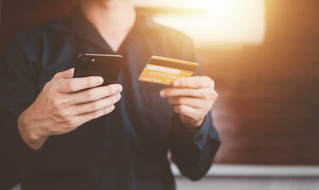 Mobile payment with wallet app via smartphone and credit card technology. Businessman shopping...