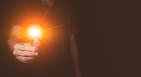 Businessman hand hold Virtual lightbulb. New ideas inspiration and innovation technology concept....
