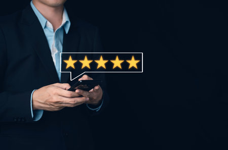 Businessman customer reviews 5 Stars with smartphone. Customer service evaluation and satisfaction....