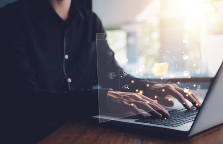 Document Management System (DMS). Digital online document database and paperless office. Businessman hand typing notebook (Laptop) with process automation to efficiently manage files.の写真素材