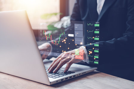 Buy and Sell. Stock chart or cryptocurrency chart with businessman hand typing notebook (Laptop). Statistics graph and char growing graph. Success business concept.の写真素材