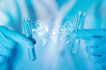 Healthcare and science technology. Scientist hand hold test tubes filled with blue sample chemicals...