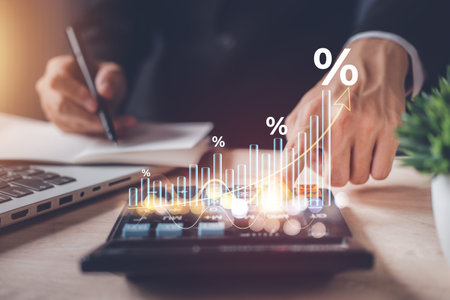 Investment in percentage. income tax paid, dividend, interest rate and corporations. Businessman calculating with calculator, laptop (notebook) of return on financial research, report, investment.の写真素材