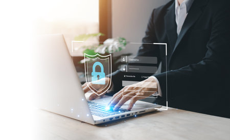 Username and password (Login) with biometric identification fingerprint scanner, encryption for technology cyber security internet and networking system. Businessman hand typing notebook (Laptop).の写真素材