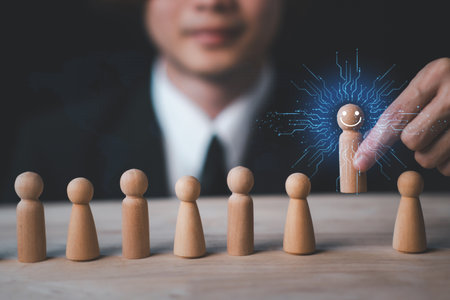 HR manager (human resources) or Employer hand choose takes person wooden doll wite face smile. Leader stands out from crowd. Looking for good worker. HR, HRM, HRD concepts.の写真素材