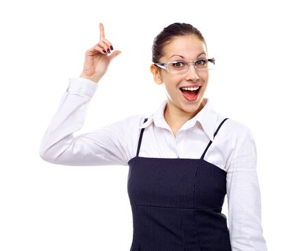 Portrait of young beautiful woman pointing up at copyspace over white backgroundの写真素材