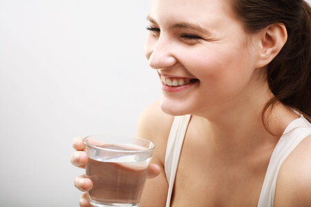 Smiling Young Woman with glass of Water