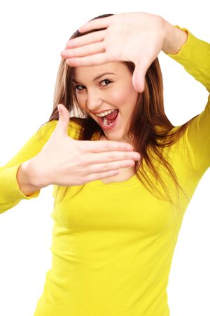 Portrait of cheerful Caucasian woman making frame gesture on white backgroundの写真素材