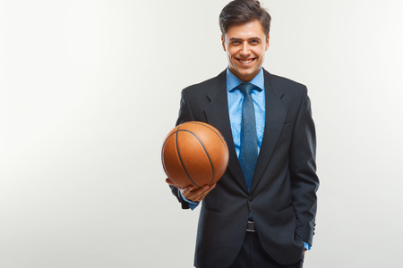 Happy Businessman with  ball against white backgroundの写真素材