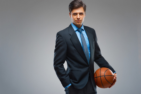 Businessman with ball against gray backgroundの写真素材