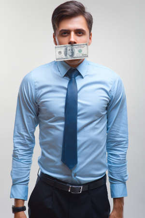 Businessman and Money on mouthの写真素材
