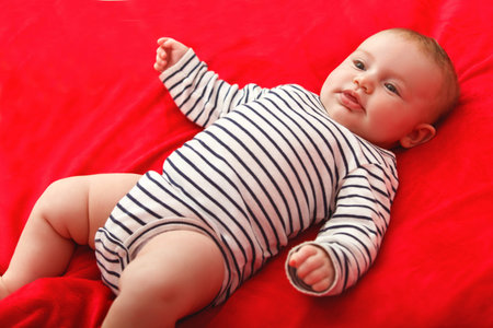 Smiling Baby Girl are Lying in the Bed