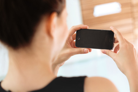 Close up of a woman using mobile smart phoneの写真素材