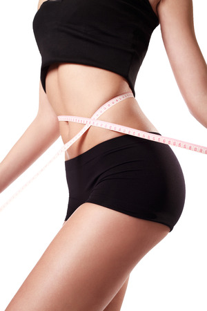 Woman measuring her waistの写真素材