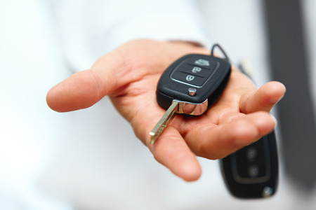 Car Keys. Seller hand giving keysの写真素材