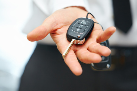 Car Keys. Seller hand giving keysの写真素材