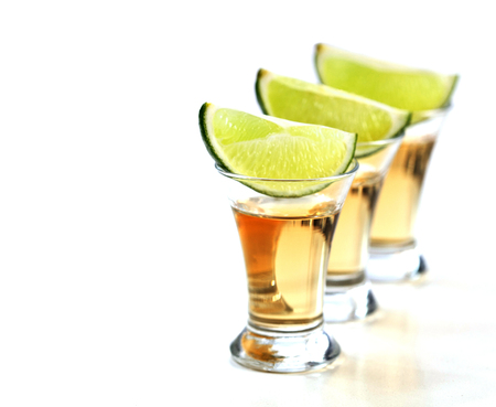 Tequila shots with lime on white background.の写真素材