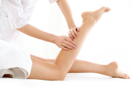 Foot Massage in the Spa Salon isolated on Whiteの写真素材