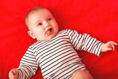 Smiling Baby Girl are Lying in the Bed
