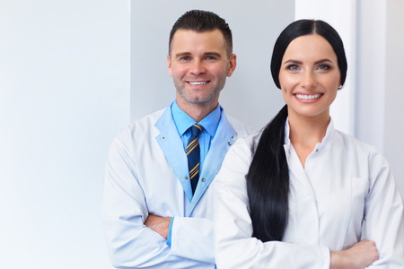 Dentist Team at Dental Clinic. Two Smiling Doctors at their Workplaceの写真素材