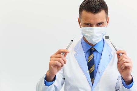 Dentist with a Tool on a White Backgroundの写真素材