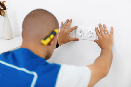 Electrician Installing Wall Socketの写真素材