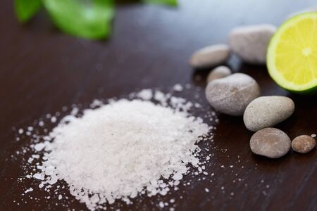 Spa Background. Sea Salt with Lime Stones and Candle . Body scrub.の写真素材