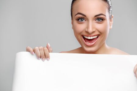 Happy woman showing blank signboardの写真素材