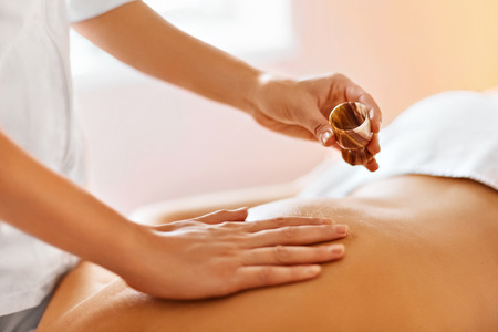 Body Massage. Spa Therapy. Masseur Doing Massage On Beautiful Young Healthy Caucasian Woman Body In  Spa Salon. Beauty Treatment Concept. Skincare, Wellbeing, Wellness, Lifestyle.の写真素材