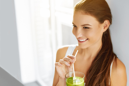 Healthy Food Eating. Happy Beautiful Smiling Woman Drinking Green Detox Vegetable Smoothie. Diet. Healthy Lifestyle, Vegetarian Meal. Drink Juice. Health Care And Beauty Concept.