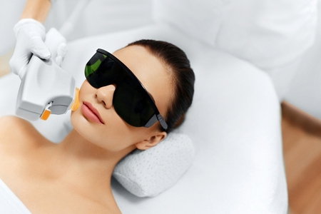 Skin Care. Young Woman Receiving Facial Beauty Treatment, Removing Pigmentation At Cosmetic Clinic. Intense Pulsed Light Therapy. IPL. Rejuvenation, Photo Facial Therapy. Anti-aging Procedures.