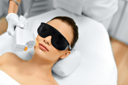 Skin Care. Young Woman Receiving Facial Beauty Treatment, Removing Pigmentation At Cosmetic Clinic. Intense Pulsed Light Therapy. IPL. Rejuvenation, Photo Facial Therapy. Anti-aging Procedures.の写真素材