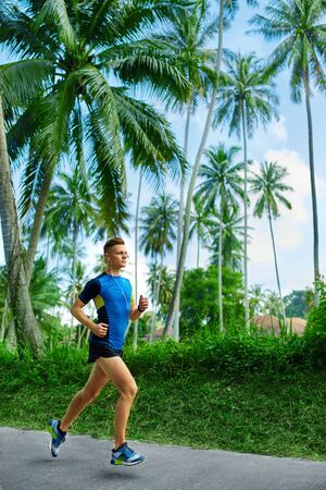 Young Male Runner Running On Road.の写真素材