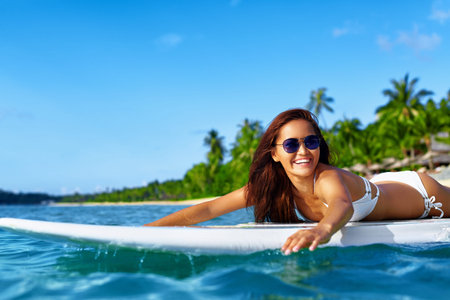 Summer Adventure. Water Sports. Happy Carefree Sexy Woman In Bikini Surfing, Lying On Paddle, Surf...