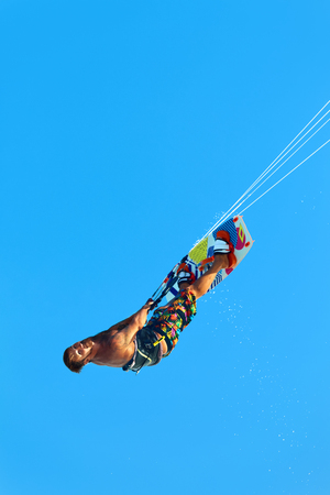 Extreme Water Sport. Kiteboarding, Kitesurfing Action. Professional Kiter Makes Difficult Trick In Air. Active Lifestyle. Hobby. Recreational Sporting Activity. Sports. Summer Fun, Adventure.の写真素材