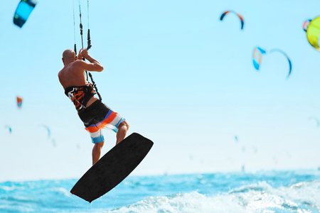 Water Sports. Kiteboarding, Kitesurfing. Kiter Jumping On Waves In Ocean. Extreme Sport Action. Recreational Sporting Activity. Healthy Active Lifestyle. Summer Fun, Adventure, Travel Vacation. Hobbyの写真素材