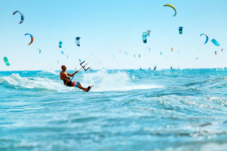 Kiteboarding, Kitesurfing. Water Sports. Professional Kite Surfer In Action On Waves In Ocean. Extreme Sport. Healthy Active Lifestyle. Hobby. Recreational Sporting Activity. Summer Fun, Adventureの写真素材