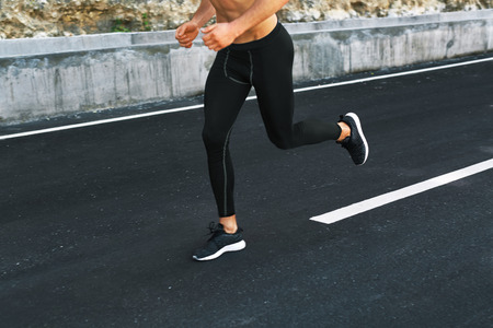 Sport. Close Up Of Sporty Male Legs In Sportwear And Sneakers Running On Road. Healthy Active Athletic Runner Man Jogging During Outdoor Workout, Exercising And Training For Marathon. Fitness Conceptの写真素材