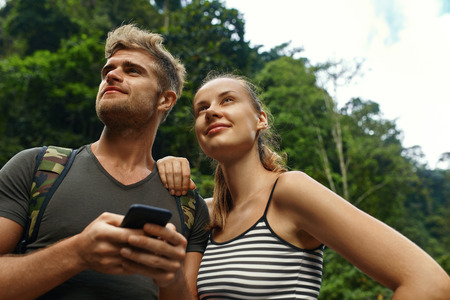 Travel And Tourism. Tourist People Adventure On Summer Vacation. Couple Of Beautiful Happy Cheerful Young Traveler Friends, Man And Woman Enjoying Nature Of Tropical Forest In Summer. Active Lifestyleの写真素材